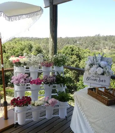 Flower bar cart with tiered riser and galvanized pails, equipment-only rental setup