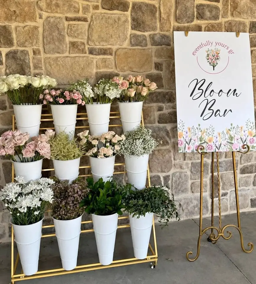 Full flower bar experience styled with fresh blooms and eventfully yours gr branded Bloom Bar sign