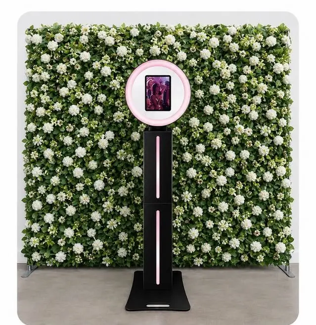 Photo booth in front of an 8ft by 8ft white flower wall